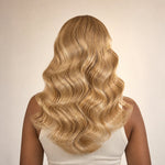 Back view of a full #27/#613 blonde blend body wave crochet human hair installation with soft waves
