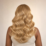 Back view of a full #27/#613 blonde blend body wave crochet human hair installation with soft waves