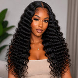 Black woman front view wearing long UrbanChichair deep wave tape-in hair extensions with glossy black waves and natural volume.