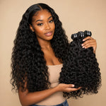 Black woman holding UrbanChichair Virgin Natural Wave human hair bundles while wearing long natural black wave extensions.