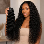 Black woman holding raw water wave human hair bundle while wearing long glossy water wave extensions by UrbanChichair