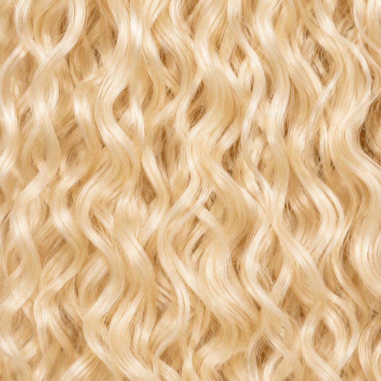 Black woman wearing #613 blonde Burmese curly crochet hair styled in soft boho braids