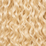 Black woman wearing #613 blonde Burmese curly crochet hair styled in soft boho braids
