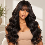 Black woman wearing UrbanChicHair loose body wave glueless human hair wig with bangs, featuring long natural black waves, soft volume and a natural-looking finish.
