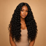 Black woman wearing UrbanChichair Raw Natural Wave Bundles in a long full natural wave hairstyle with glossy black human hair texture