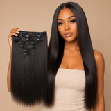 Black woman wearing UrbanChichair Yaki Straight clip-in hair extensions while holding the matching natural black clip-in hair set