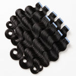 Body Wave Invisible Tape In Hair Extensions by UrbanChichair, glossy black human hair tape-ins with soft waves and blue protective tape tabs