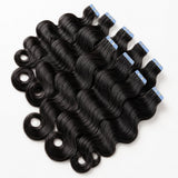 Body Wave Invisible Tape In Hair Extensions by UrbanChichair, glossy black human hair tape-ins with soft waves and blue protective tape tabs