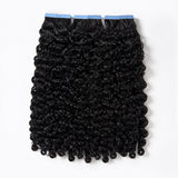 Burmese Curly Tape In Hair Extensions by UrbanChichair, double drawn black human hair with defined curls and blue tape tabs on a clean white background