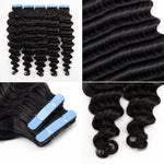 Close-up of UrbanChichair deep wave tape-in human hair extensions showing glossy black waves, smooth texture, and defined curl pattern.