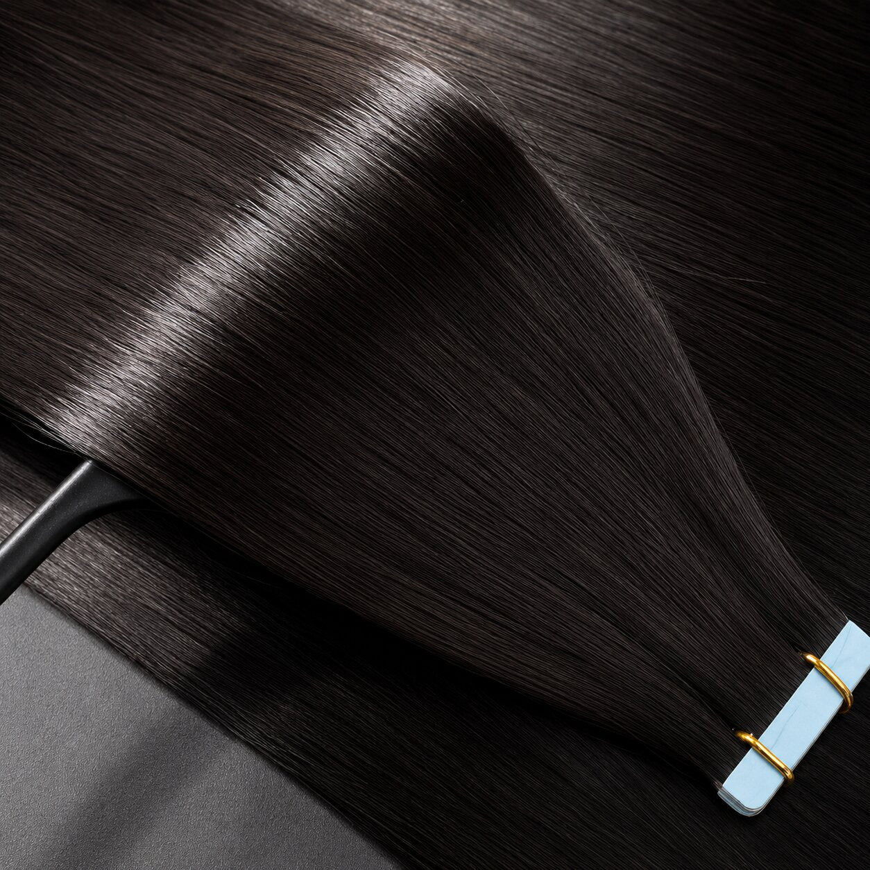 Close-up of premium straight tape-in human hair extensions with silky smooth texture, double drawn fullness, and natural shine by Urban Chic Hair.