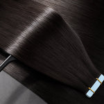 Close-up of premium straight tape-in human hair extensions with silky smooth texture, double drawn fullness, and natural shine by Urban Chic Hair.