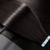 Close-up of premium straight tape-in human hair extensions with silky smooth texture, double drawn fullness, and natural shine by Urban Chic Hair.