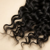 Close-up of soft natural black Natural Wave Human Crochet Hair texture with loose waves and feathered ends.