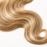 Close-up of the honey blonde and light blonde #27/#613 blend and soft body wave human hair texture