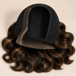 Close-up of the left C part and pre-plucked hairline on a brown highlight HD lace wig.