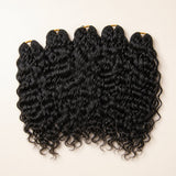 Five bundles of UrbanChichair natural black Natural Wave Human Crochet Hair on a warm ivory background.