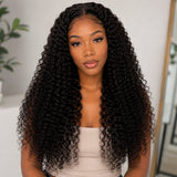 Front portrait of a Black woman wearing UrbanChichair kinky curly tape in hair extensions with long defined curls, natural shine, and full volume.