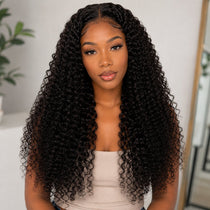 Front portrait of a Black woman wearing UrbanChichair kinky curly tape in hair extensions with long defined curls, natural shine, and full volume.