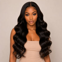 Front view model wearing UrbanChichair Body Wave Invisible Tape In Hair Extensions with long glossy black waves and natural seamless volume