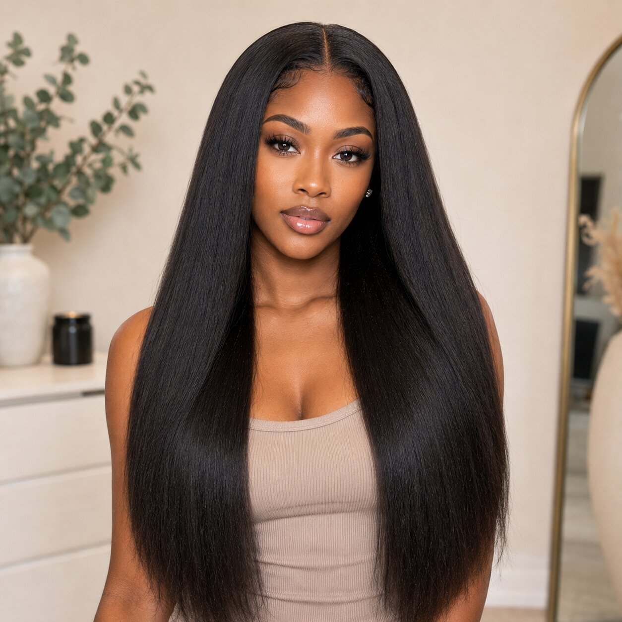 Front view of Black woman wearing UrbanChichair Virgin Yaki Straight Bundles with sleek long textured human hair.