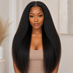 Front view of Black woman wearing long kinky straight tape in human hair extensions with natural volume and soft textured finish
