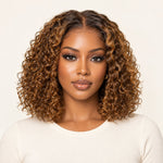 Front view of a model wearing an UrbanChichair caramel brown highlight deep curly glueless wig with a middle part.