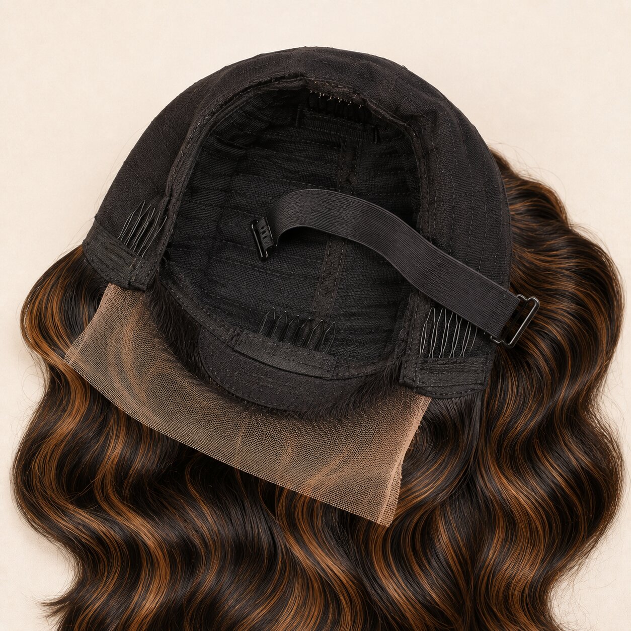 Interior construction concept of a brown highlight glueless wig with minimalist lace, combs, elastic band and adjustable straps.