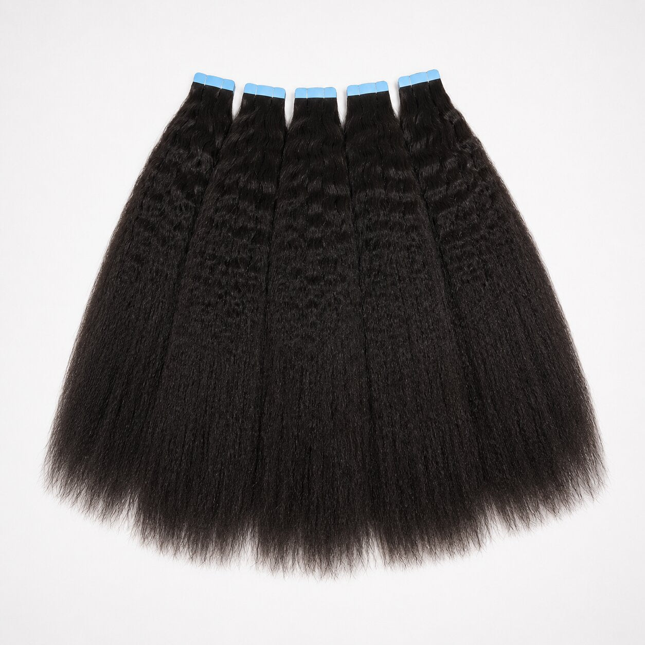 Kinky straight tape in hair extensions flat lay showing full double drawn human hair wefts with natural texture and thick ends