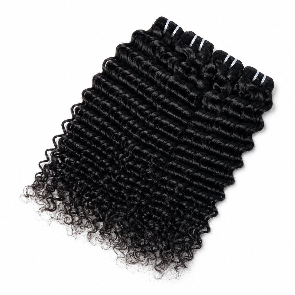 Raw water wave human hair bundles in natural black color displayed on white fur with green plant decor, showing glossy curl texture and full ends by UrbanChichair
