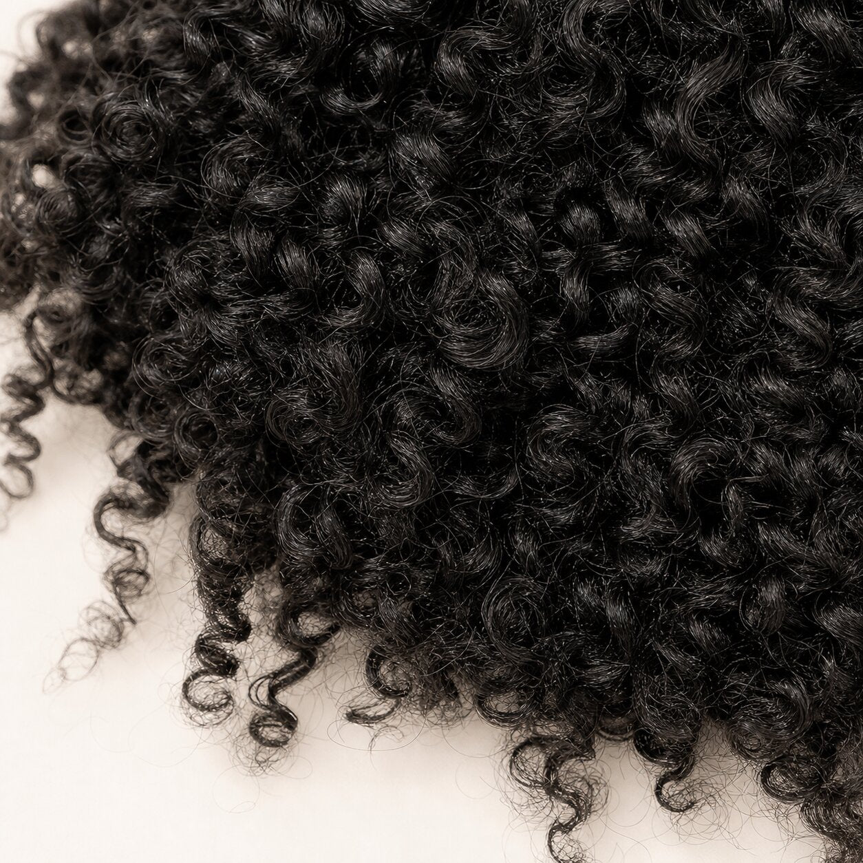 Seven UrbanChichair pre-separated kinky curly crochet hair strands with slim looped tops for easy installation
