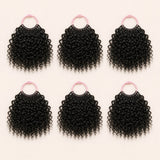 Six bundles of Spanish Curl human hair crochet strands arranged for a full installation