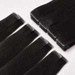 Straight Invisible Tape In Hair Extensions laid flat, showing smooth black human hair with seamless invisible tape tabs.