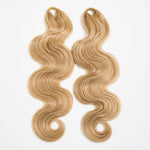 Two bundles of #27/#613 blonde blend body wave pre-looped human crochet hair on a clean white background