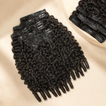 UrbanChichair Burmese Curly Finger Coil Ends Seamless Clip-In Human Hair Extensions in natural black, displayed in a premium flat lay with defined curls and visible clip-in wefts.