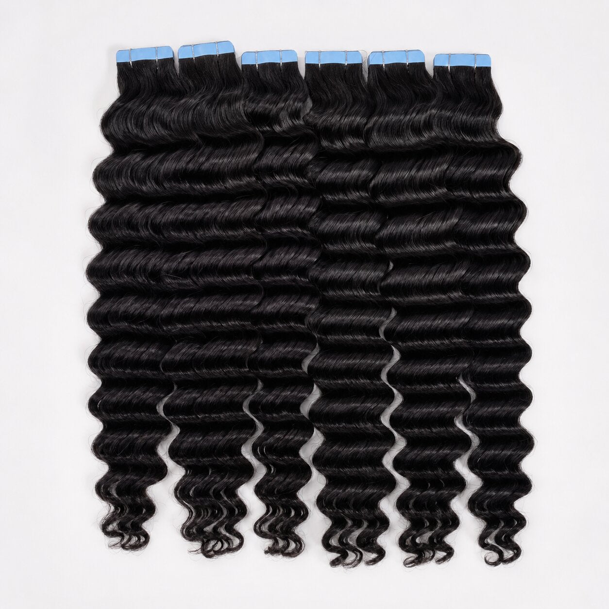 UrbanChichair deep wave tape in hair extensions in natural black color with blue adhesive tabs, showing soft shiny human hair waves.