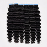 UrbanChichair deep wave tape in hair extensions in natural black color with blue adhesive tabs, showing soft shiny human hair waves.