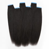 Yaki Straight tape in hair extensions in natural black human hair with blue adhesive tabs, showing soft textured straight hair from UrbanChichair.